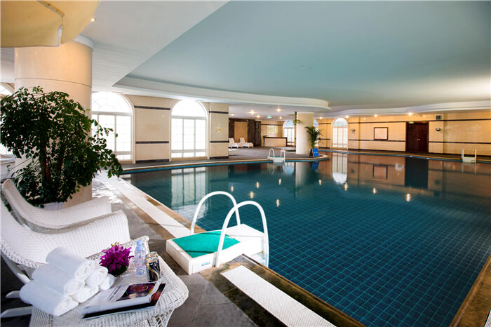 swimming pool in hotel uses dark blue pool tiles for exalted style.jpg