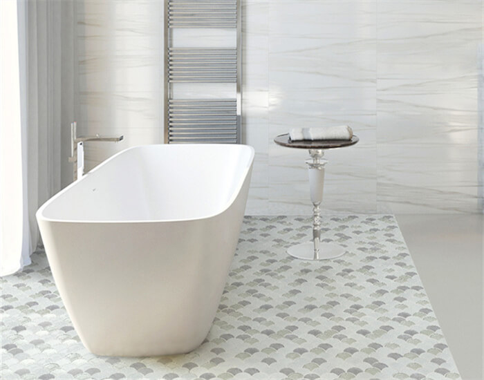 shower room using blended material fan shaped mosaic tile on the floor that surrounds the bathtub.jpg