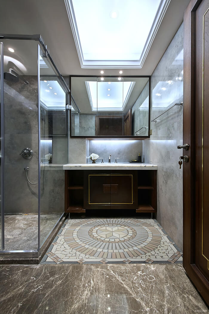 a stone mosaic floor medallion decorated shower.jpg