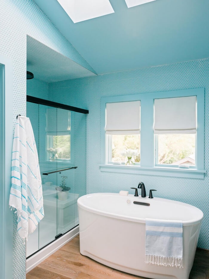 a beautiful bathroom with blue penny tile all around decorated.jpg