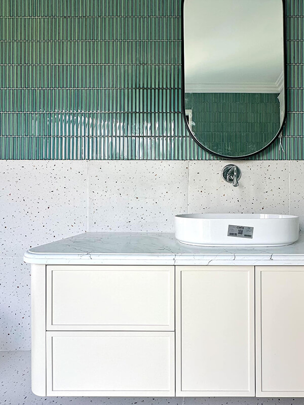 bathroom wall with dark green kit kat tiles